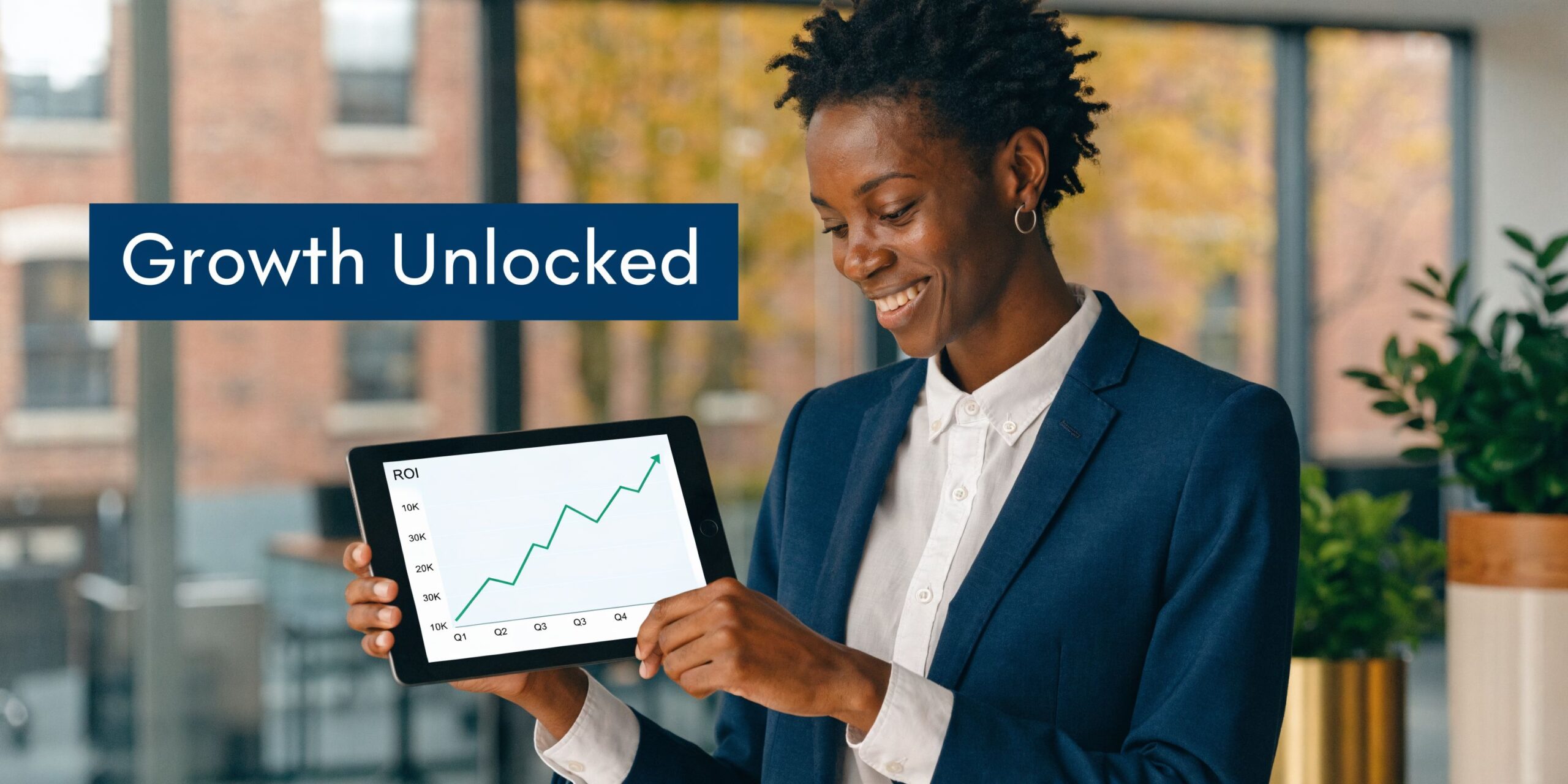 A professional woman in a suit holding a tablet displaying a positive upward trending ROI line graph.